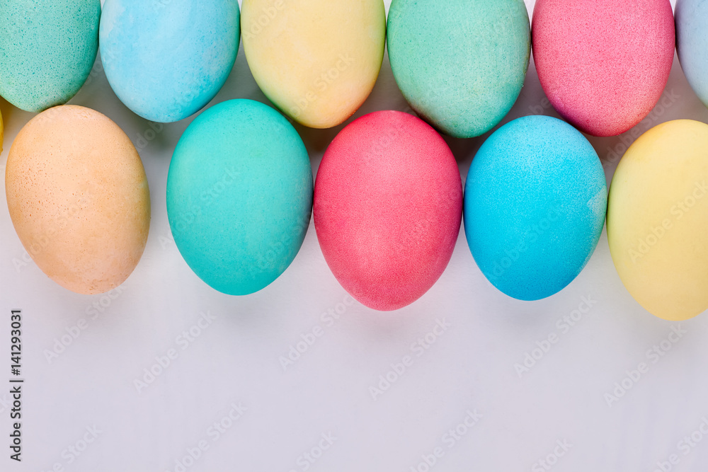 Painted eggs on white surface. Colorful Easter eggs close up. The art of simple things. Painted eggs on white surface. Colorful Easter eggs close up. The art of simple things.