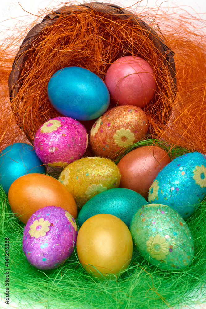 Happy Easter. Colorful Easter eggs in a basket on the artificial grass Happy Easter. Colorful Easter eggs in a basket on the artificial grass