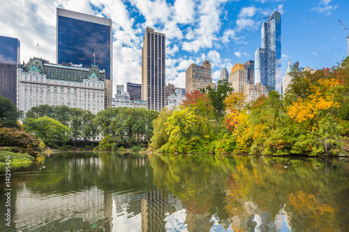 Central Park Autumn and buildings reflection in midtown Manhattan New York City