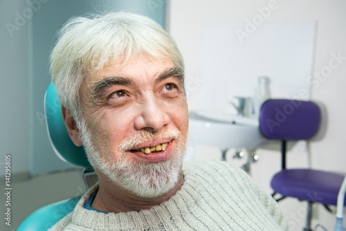 Old man with yellow teeth. Senior patient of stomatologist. Cure dental diseases.