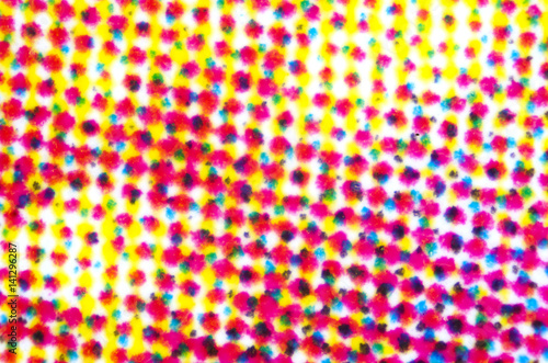 Four color printing on white paper under the microscope. CMYK Cyan Magenta Yellow and Key or black color process. Subtractive color mixing. Synthesis with primary and secondary colors. Photo.