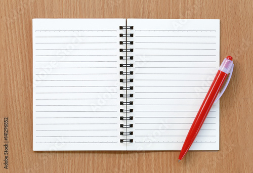 Empty notebook and red pen.