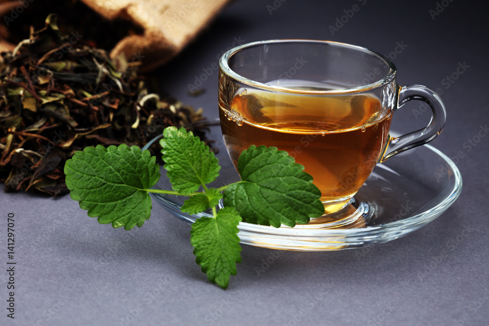 Herbal dry sri lanka tea. Mint leaf. Tea in a glass cup, mint leaves, dried tea, in a restaurant or teahouse Herbal dry sri lanka tea. Mint leaf. Tea in a glass cup, mint leaves, dried tea, in a restaurant or teahouse