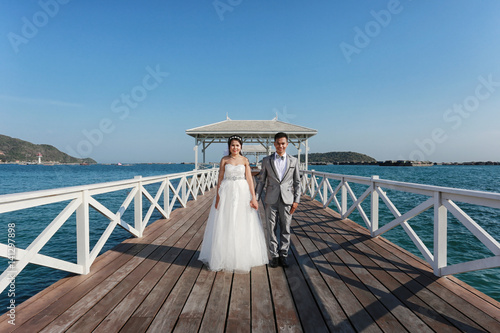 Pre Wedding photography thai couples on a wooden Atsadang bridge of Koh Si Chang Island at Thailand. photo