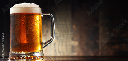 Composition with glass of beer on wooden background