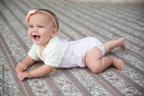 Baby girl crawling outside