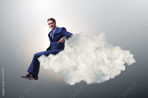 Businessman sitting on the cloud in motivitation concept