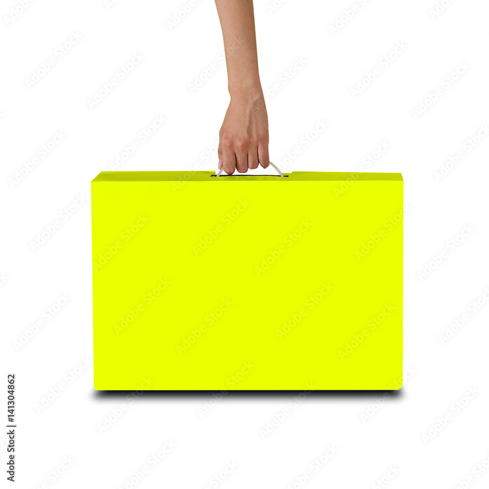Hand holds a yellow box with a handle. Packing box for laptop. Isolated on white background Hand holds a yellow box with a handle. Packing box for laptop. Isolated on white background