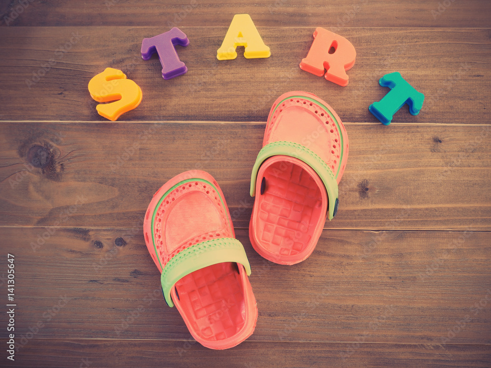 colorful children's rubber sandals and colorful alphabets START word on  wooden background Stock Photo | Adobe Stock