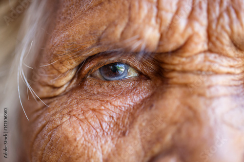 Age, Vision and old people concept - Close up of senior asian woman face and eye photo