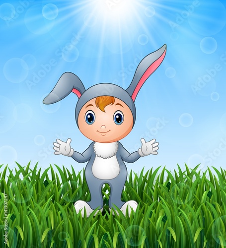 Cute bunny girl costume in the grass on a background of bright sunshine