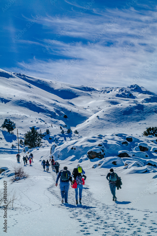 winter hiking in turkey. hiking group walking up wards to the summit of a mountain