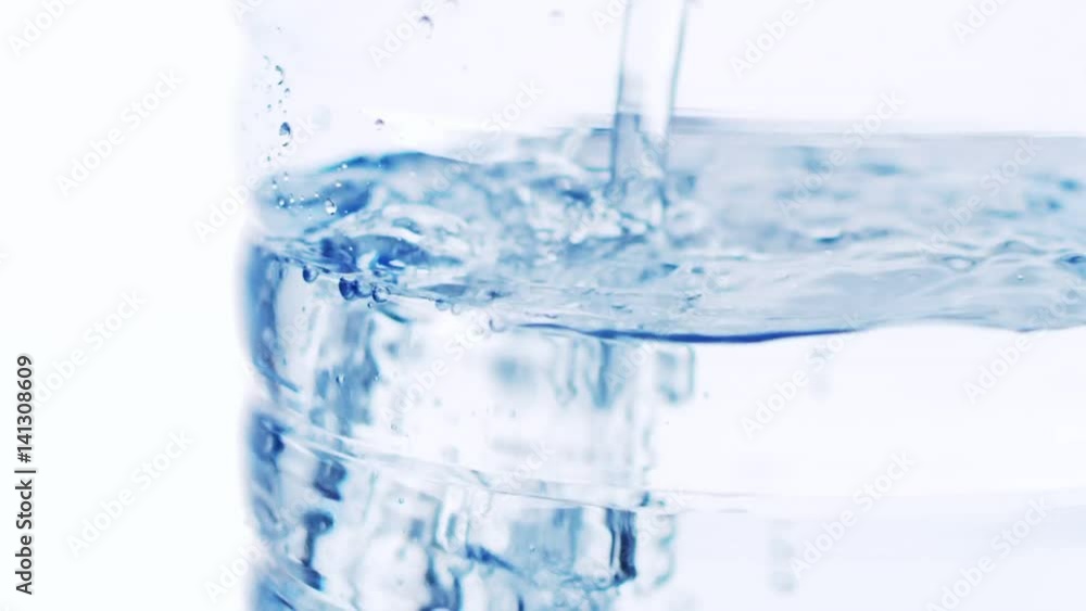 Mineral water is being poured to a bottle Mineral water is being poured to a bottle