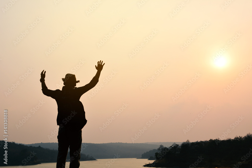 Silhouette of happy Asian hipster man backpack in nature background, Relax time on holiday concept travel , color of vintage tone and soft focus