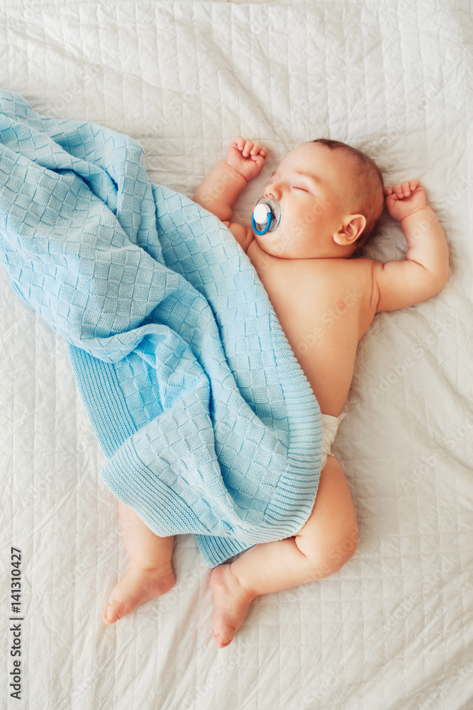 Portrait of a cute adorable white Caucasian baby newborn in diaper