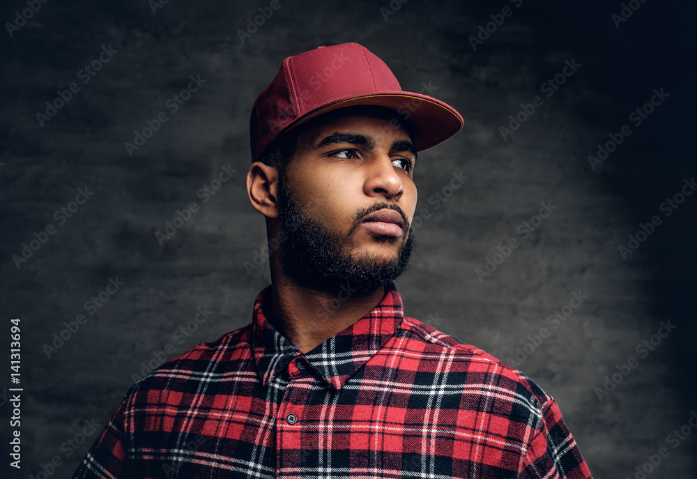 Black bearded male dressed in a red fleece shirt and a cap. Black bearded male dressed in a red fleece shirt and a cap.