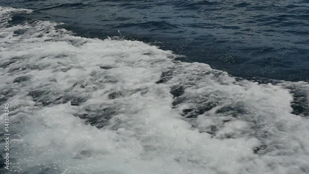 Sea foam and bubbles from the wave emanating from the motion of the motor boat. Cruise on the blue water. Extreme sport. Speed Regatta. Sea foam and bubbles from the wave emanating from the motion of the motor boat. Cruise on the blue water. Extreme sport. Speed Regatta.