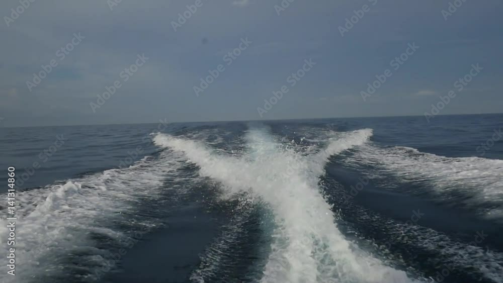Waves from a motor boat against a background of the sea horizon in Indonesia. Cruise on the blue water. Extreme sport. Speed Regatta. Waves from a motor boat against a background of the sea horizon in Indonesia. Cruise on the blue water. Extreme sport. Speed Regatta.