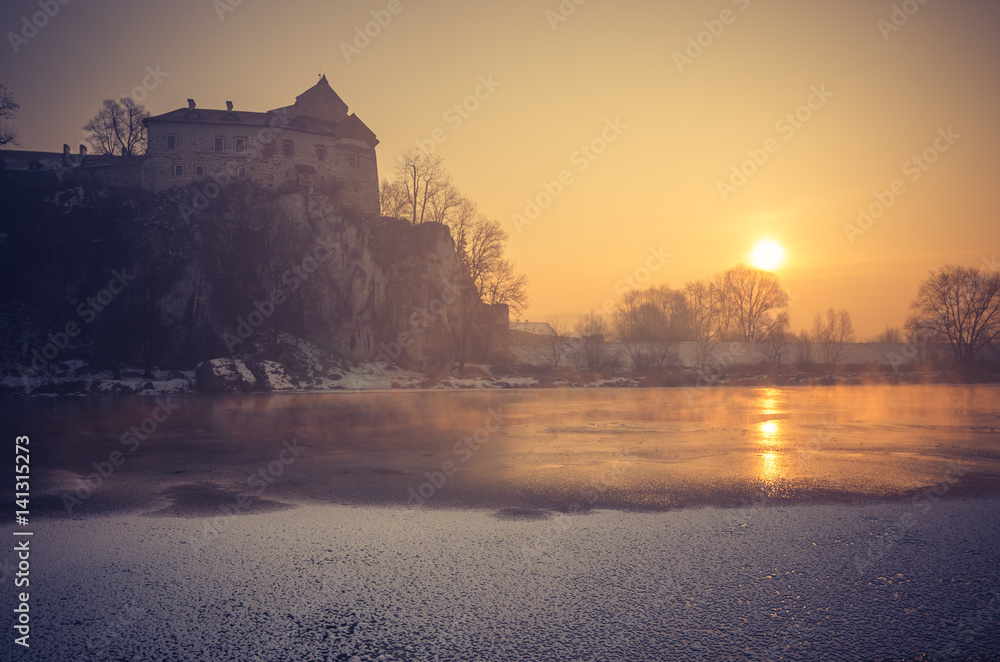 Krakow, Poland, Tyniec abbey in the morning over frozen Vistula river,