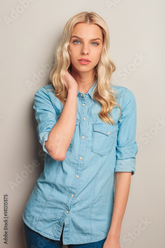 blonde casual woman hold hand on neck