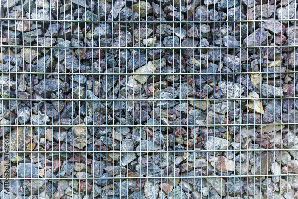 Fototapeta premium fence from the pieces of granite and metallic grates
