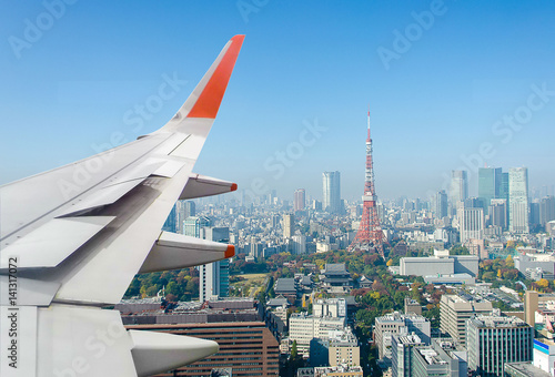 Airplane wing over Tokyo tower
