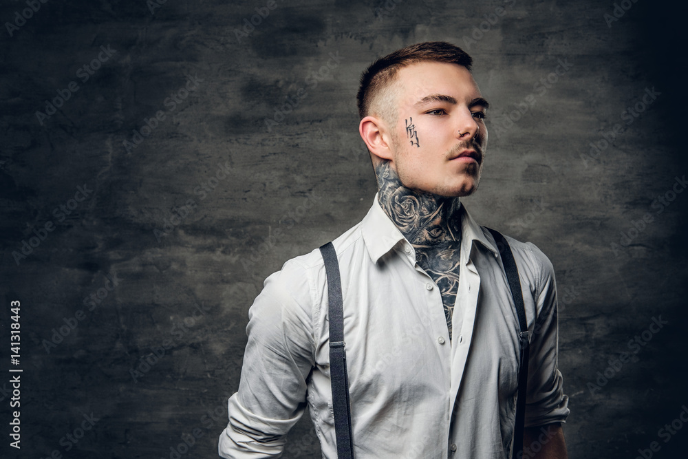 A man with a tattoo on his face and arms. A man with a tattoo on his face and arms.