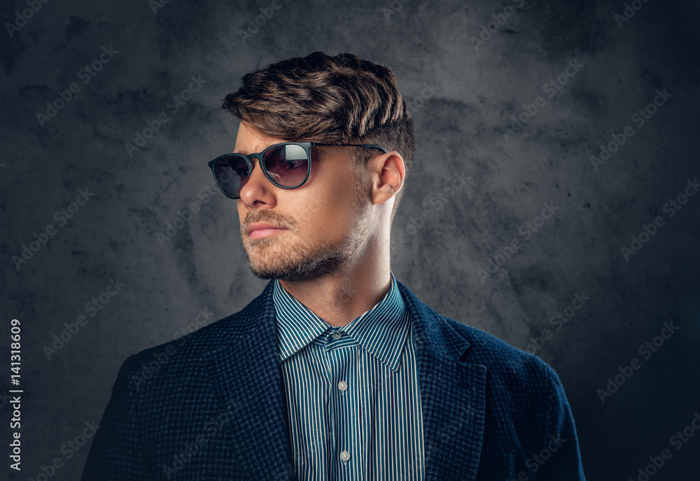 Portrait of stylish male in sunglasses over grey background. Portrait of stylish male in sunglasses over grey background.