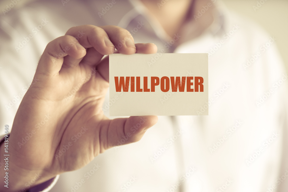 Businessman holding WILLPOWER message card Businessman holding WILLPOWER message card