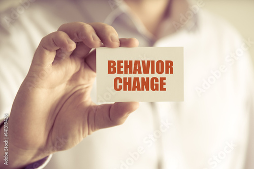 Businessman holding BEHAVIOR CHANGE message card