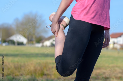 Woman doing stretching exercise before jogging