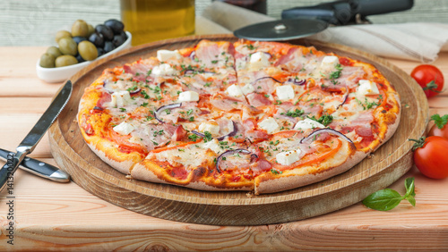 Thick greece pizza on a wooden tray