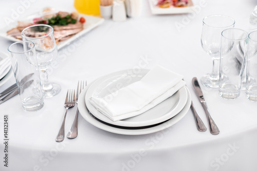 Empty plate on the table  cutlery set. Table appointments