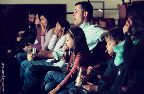 Group of people watching exciting movie