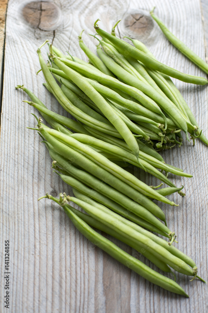 Pile of green beans on the wooden background Pile of green beans on the wooden background