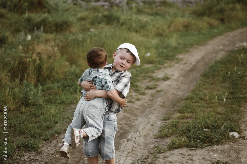 Brother and sister on a walk in the fresh air.