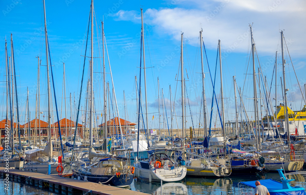 Set of the yachts standing on pier in bright sunny day