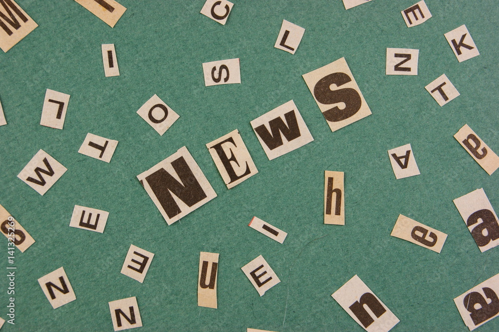Collage word cut from newspaper on green background Collage word cut from newspaper on green background
