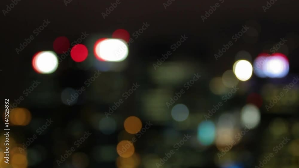 Evening city illumination. Light shines through the windows. Blurred background. Singapore. Evening city illumination. Light shines through the windows. Blurred background. Singapore.