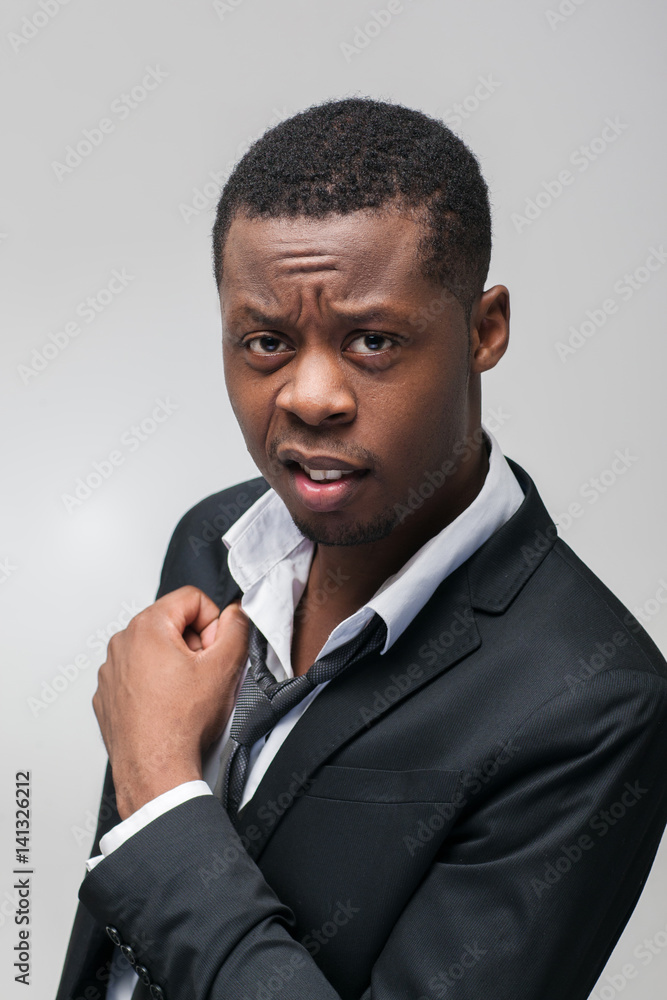 Portrait of mistrustful african american guy on grey background. Non-acceptance, antipathy, disgust. Portrait of mistrustful african american guy on grey background. Non-acceptance, antipathy, disgust.