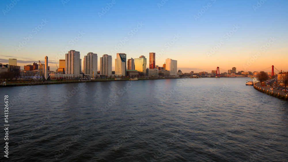 Rotterdam skyline and the river Meuse at suset , the Netherlands
