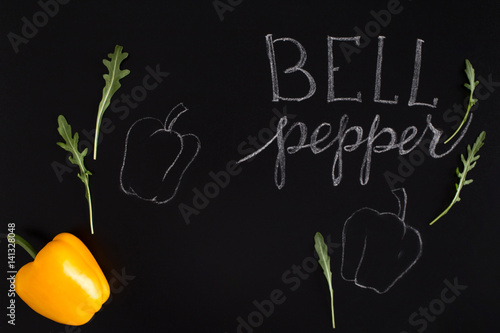 Shinny yellow bell pepper with the inscription