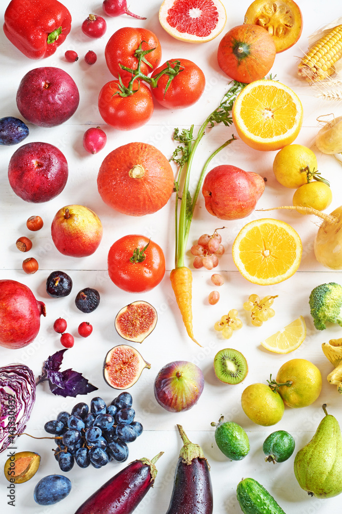 Rainbow colored fruits and vegetables on a white table. Juice and smoothie ingredients. Healthy eating / diet concept. Rainbow colored fruits and vegetables on a white table. Juice and smoothie ingredients. Healthy eating / diet concept.
