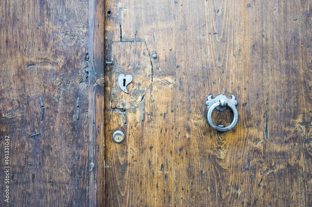 Details of an ancient Italian door in Florence, Italy. Details of an ancient Italian door in Florence, Italy.
