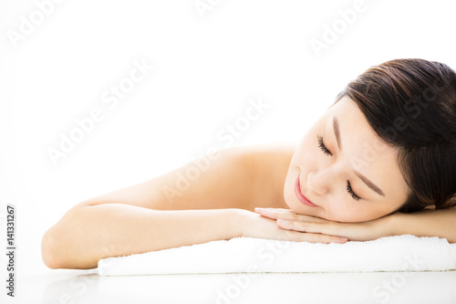 Beautiful woman  lying down on towel during skin care treatment.
