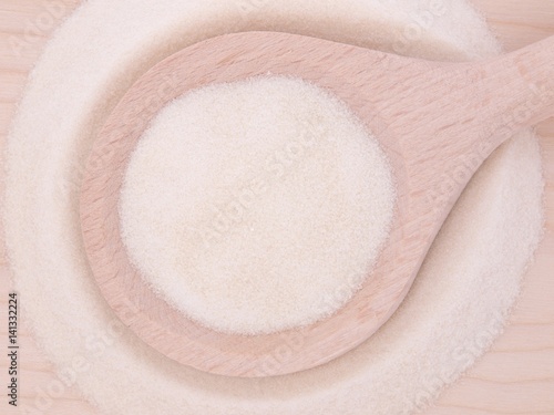 Pork gelatin powder in wooden spoon