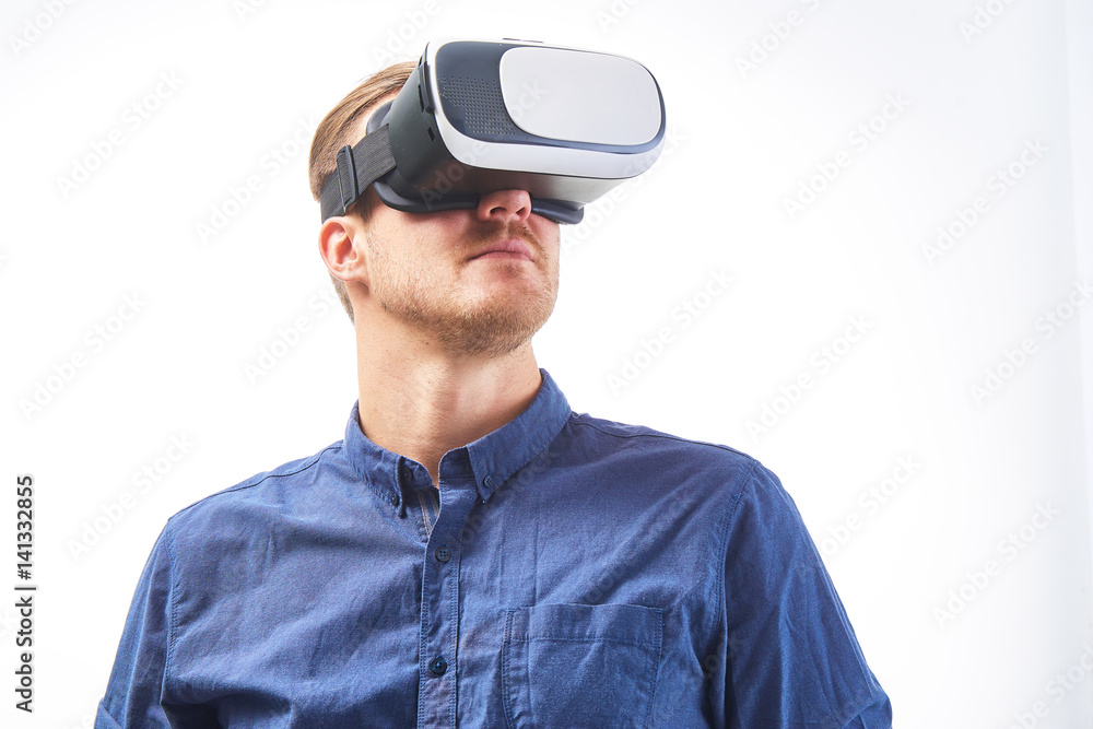 Man wearing virtual reality goggles. Studio shot, isolated background headshot close up portrait Man wearing virtual reality goggles. Studio shot, isolated background headshot close up portrait