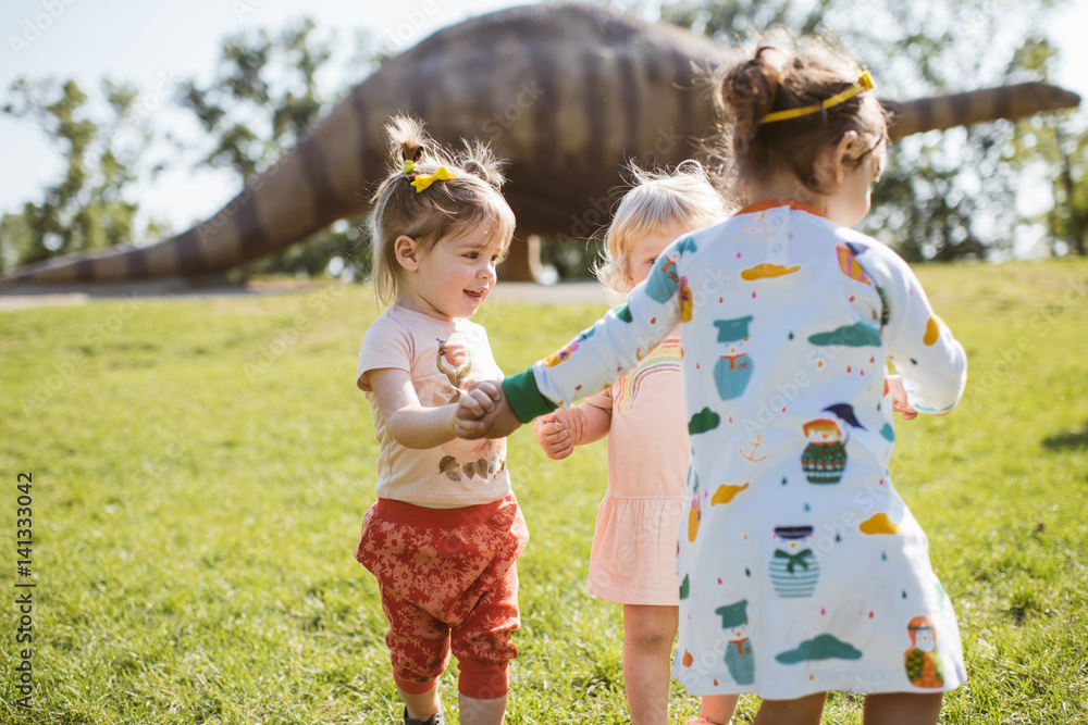 young girls play to the dinosaur park young girls play to the dinosaur park