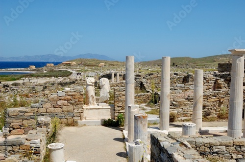 Marble ruins of ancient city/ House ruins of ancient Athenians: Cleopatra and Dioscoride. And remains of a monument to them. Island of Delos, Cyclades, Greece. Near island of Santorini. On  tour photo