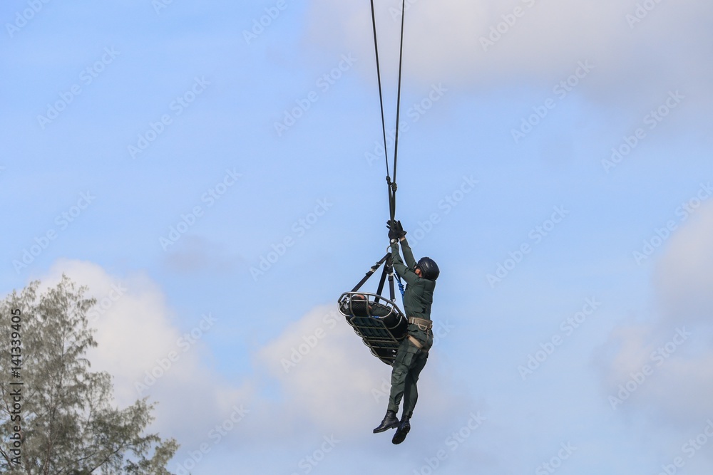 Soldier rescue emergency by army helicopter with rope  on blue sky